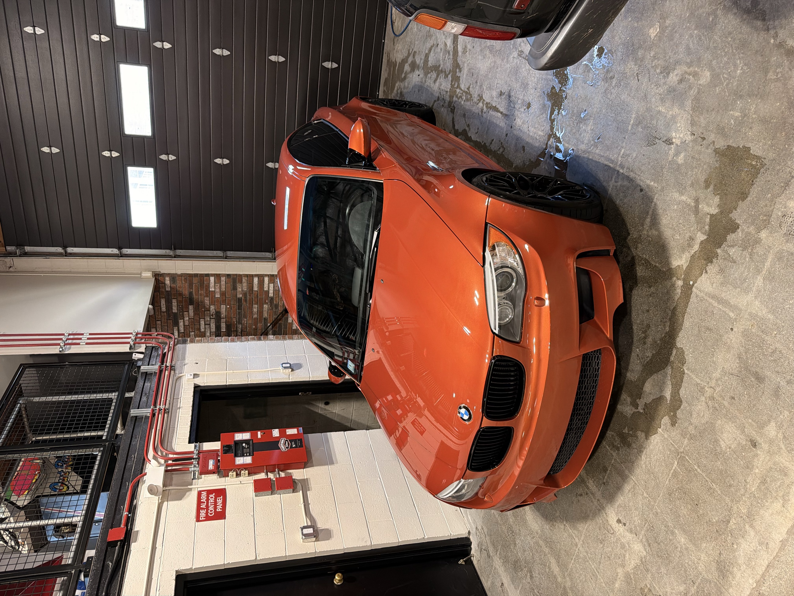 Will's Valencia Orange BMW 1M in the workshop