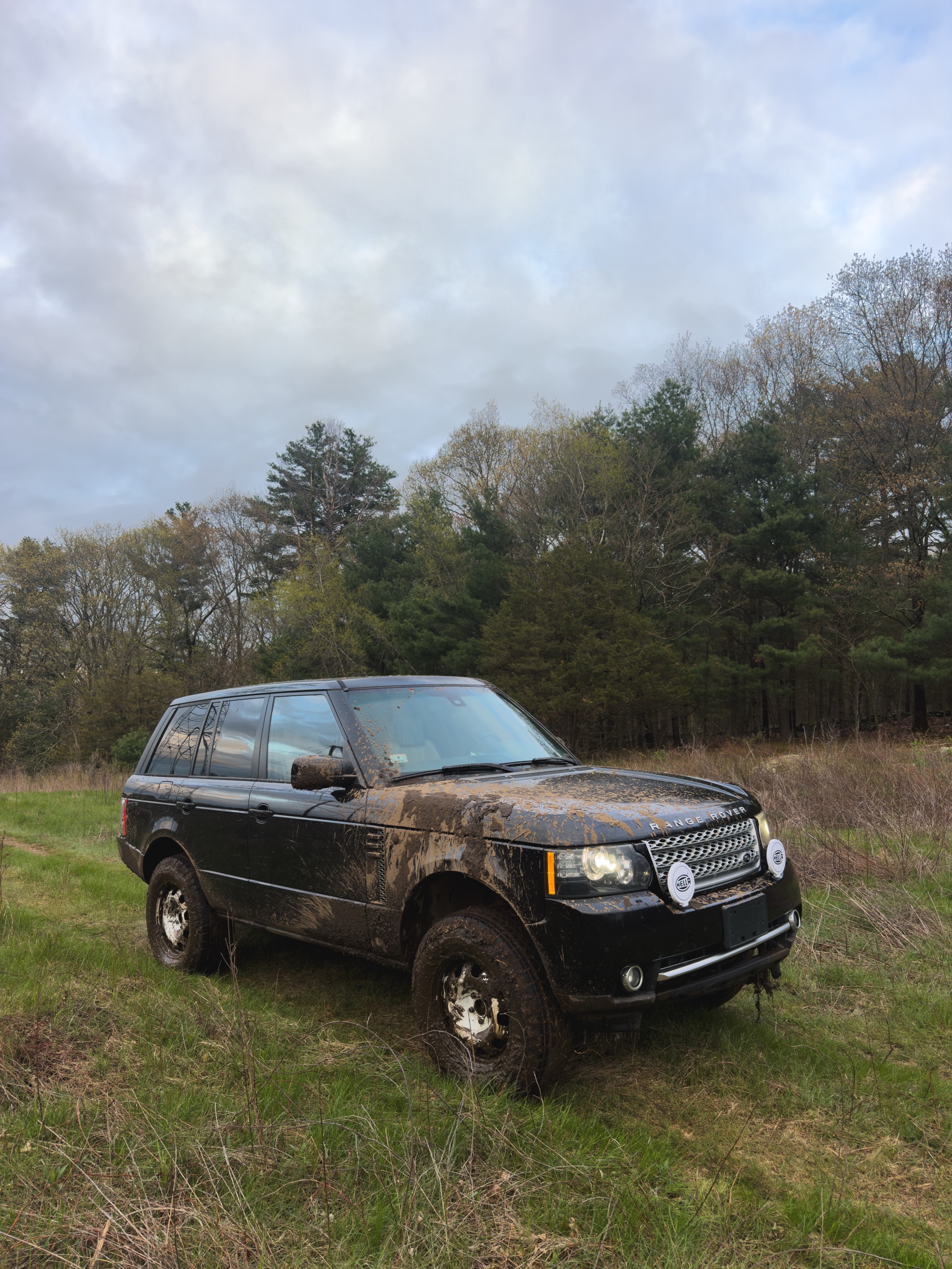 Will's mud-covered 2011 Range Rover HSE in a field